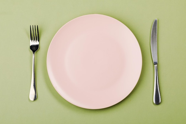 Knife plate and fork on a green background