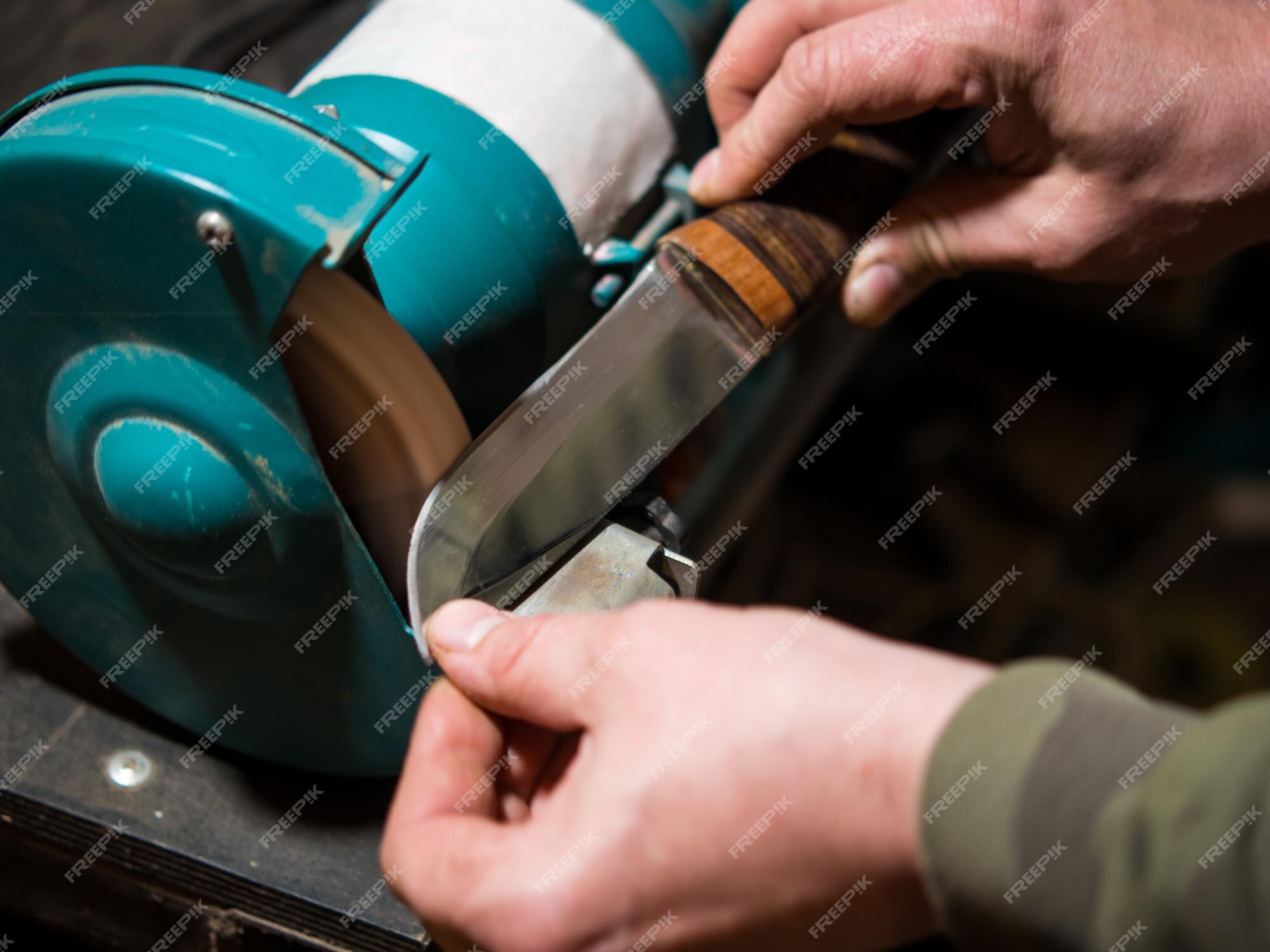 Premium Photo  Knife sharpener and a hand with a blade a man sharpens a  knife on a grinder