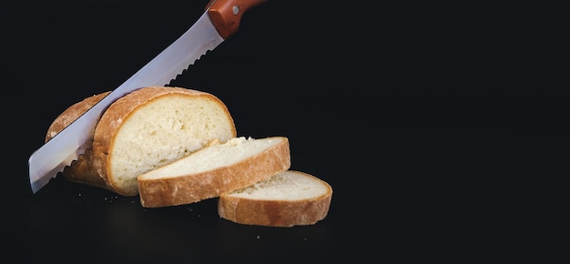 Knife slicing freshly baked loaf of bread Seed bread homemade breadcutting bread