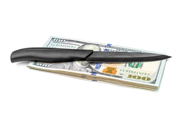 Knife with heap of dollar bills on white background