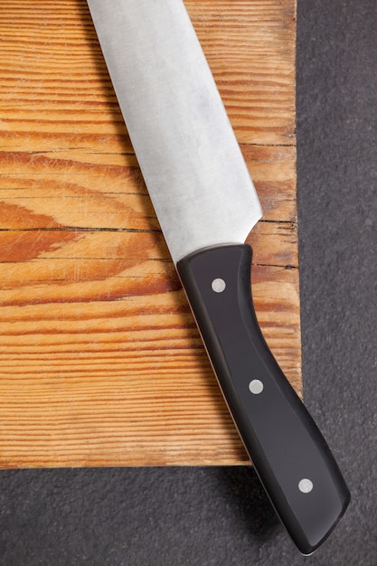 Knife on wooden board