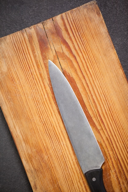 Knife on wooden board