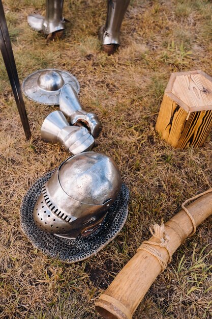 Knight's helmet sword and battle horn on the ground