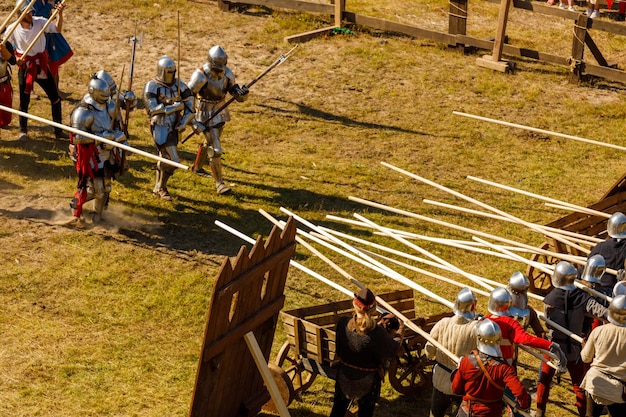 Knights in medieval armor fight at the tournament in the summer. High quality photo