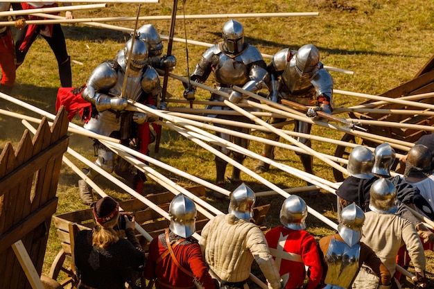 Knights in medieval armor fight at the tournament in the summer. High quality photo