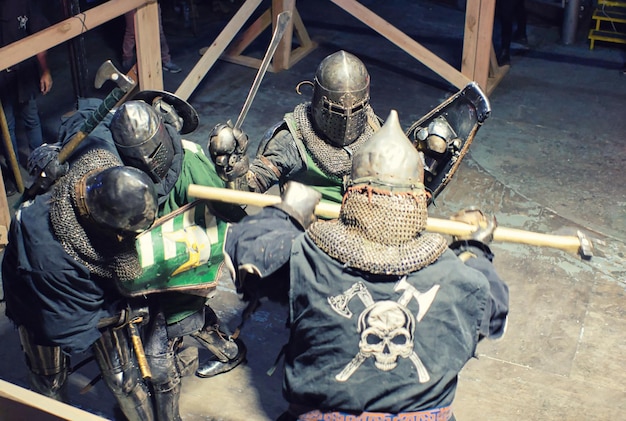 Knights in silver armor fighting in medieval combat display