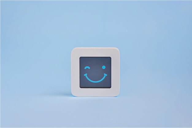 Knipogend blij emotie concept symbool van smiley op lcd-scherm geïsoleerd op gekleurde achtergrond Customer Experience Concept