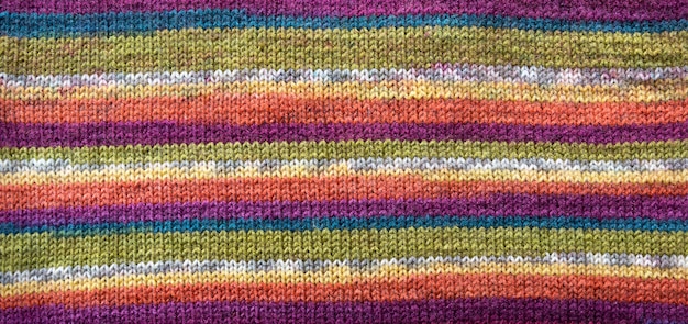 Knit pattern. Close-up of knitted wool texture. Colored pattern knit