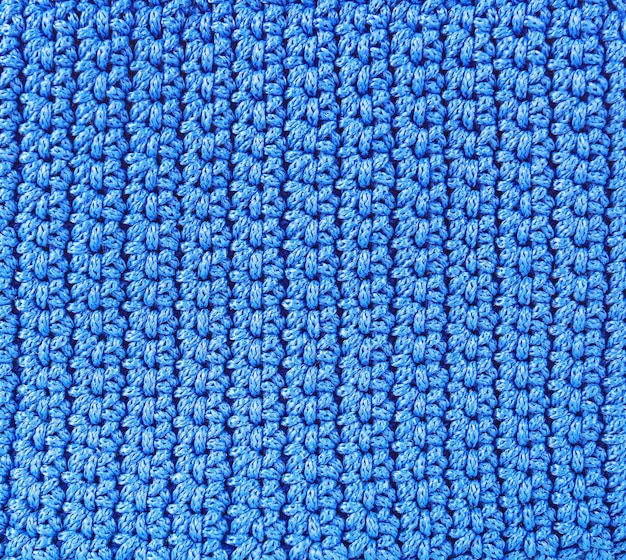 Knitted backgroundtexture of rough knitting from blue woolen threads