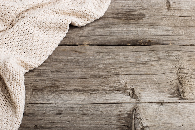 Knitted blanket on an old wooden table