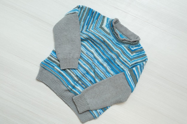 Knitted children's sweater on a white background