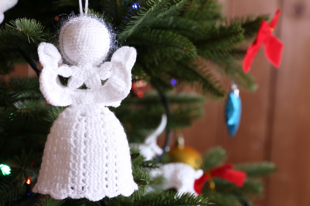 Knitted Christmas angels and other decorations on Christmas tree