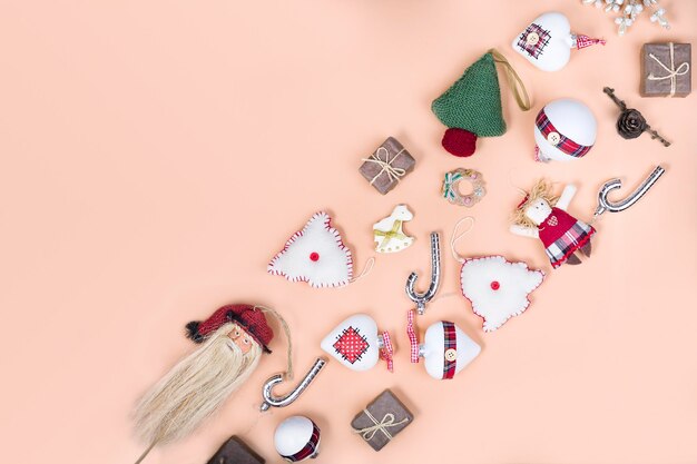 Knitted christmas tree new year baubles xmas sock snowflakes on light background in minimal