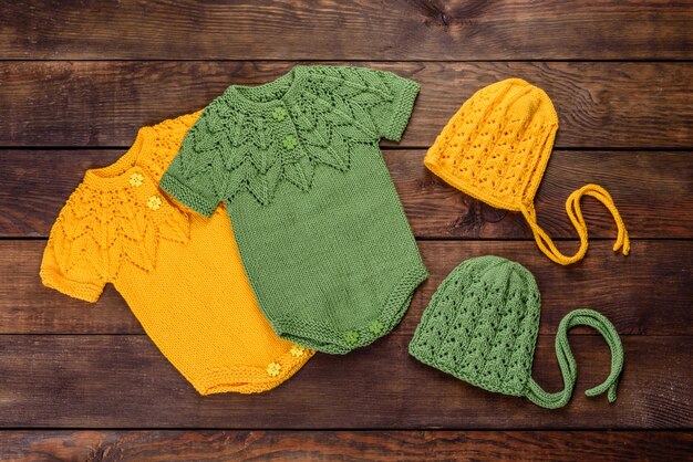 Knitted clothes made of natural wool threads for a newborn baby. Outerwear for the smallest