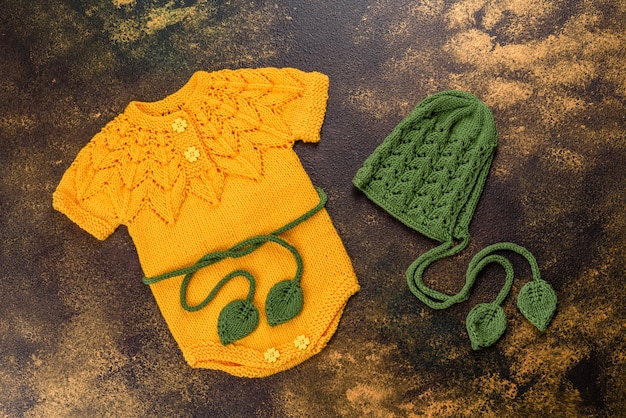 Knitted clothes made of natural wool threads for a newborn baby. Outerwear for the smallest