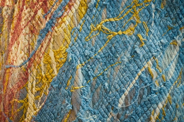 knitted colourful fabric textile handmade texture of turquoise cloth carpet wallpaper background beautiful patterns space for work