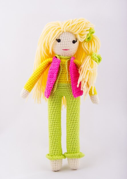 Photo knitted doll in bright clothes