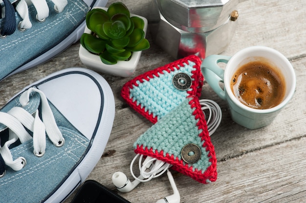 Knitted ear pods holder on wooden table