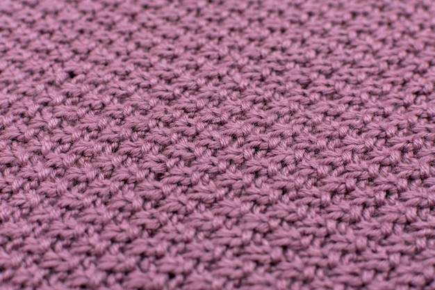 Knitted fabric pearl woolen background closeup The structure of the fabric with a natural texture Fabric background Knitted woolen background Closeup