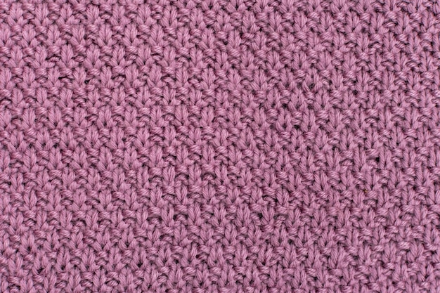 Knitted fabric pearl woolen background The structure of the fabric with a natural texture Fabric background Knitted woolen background