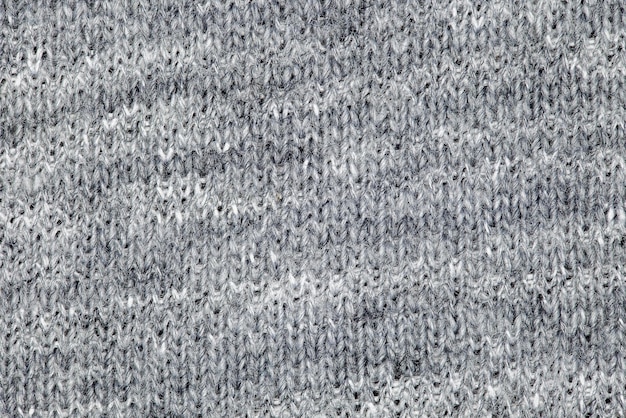 Knitted grey fabric closeup of fleecy threads uniform texture background