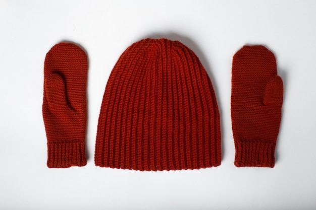 Knitted hat with red gloves isolated