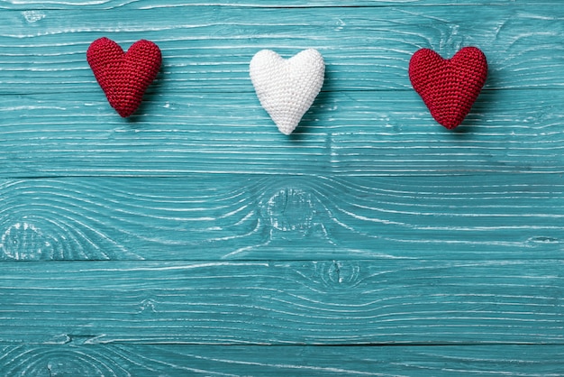 Knitted heart on a blue wooden background