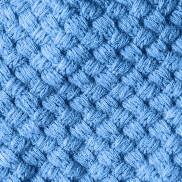 Knitted homemade Woolen textured scarf toned in trendy classic blue color.