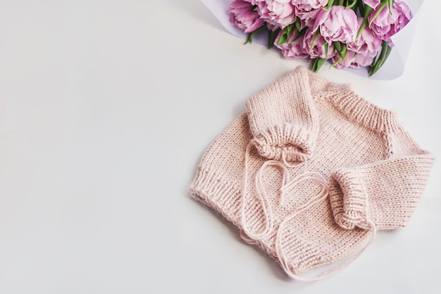 Knitted kids clothes and accessories for knitting Needlework and knitting Hobbies and creativity Knit for children Handmade Pink sweater and tulips