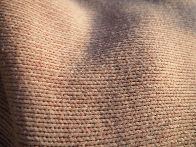 Knitted knitwear Knitted warm winter sweater or closeup jumper Wool or polyester threads Clothing production The texture of the knitted thing