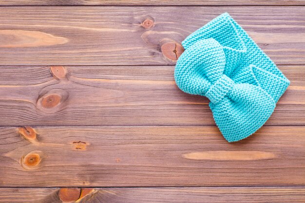 Knitted mint headband on a wooden table