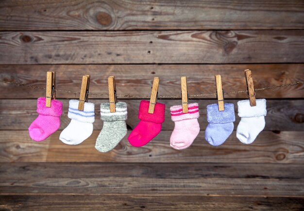 Knitted multicolored socks on a wooden wall