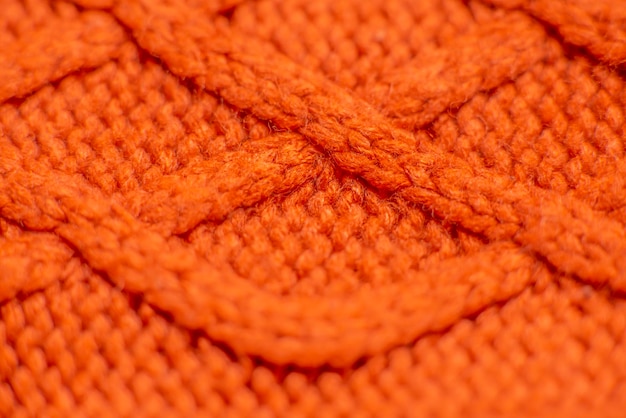 Photo knitted orange sweater close up background