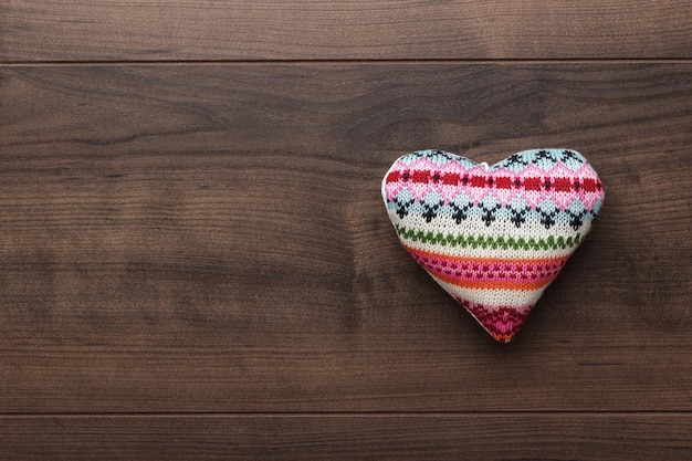 Knitted plush heart shape on the table