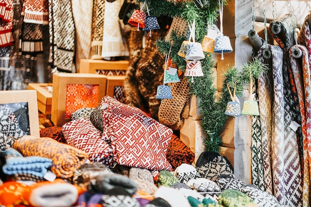 Knitted souvenirs at stalls at Christmas market in Riga in Latvia in winter.