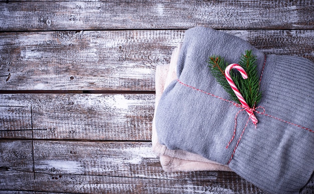 Knitted sweaters on wooden background