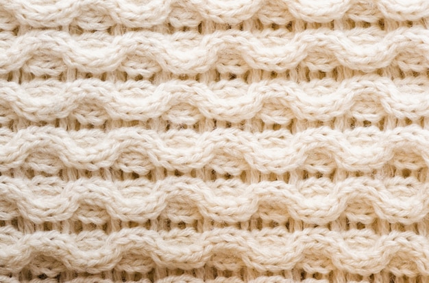 Knitted texture. Pattern fabric made of wool. Background, copy space