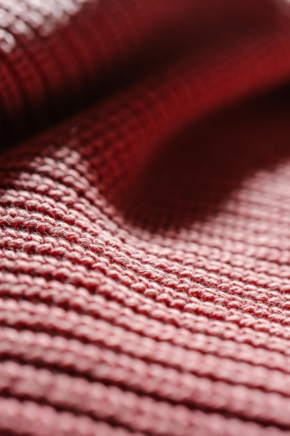 Foto texture a maglia di un maglione o di una sciarpa rosa in primo piano