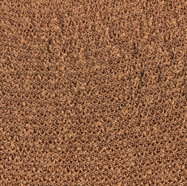 ニットの織り目加工の茶色の栗色の生地の背景。美しいオリーブブラウンの朱色の生地の質感。