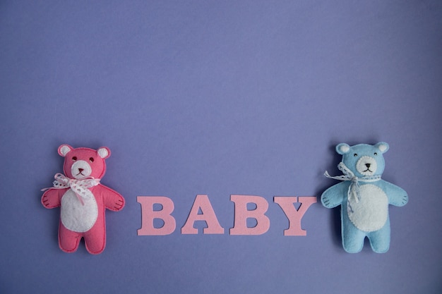 Knitted toys cloud, star, bear, ram, owl, bird pink and blue colors lie on a purple background