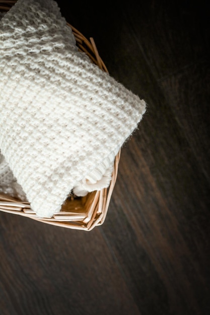 Knitted winter clothes in a basket