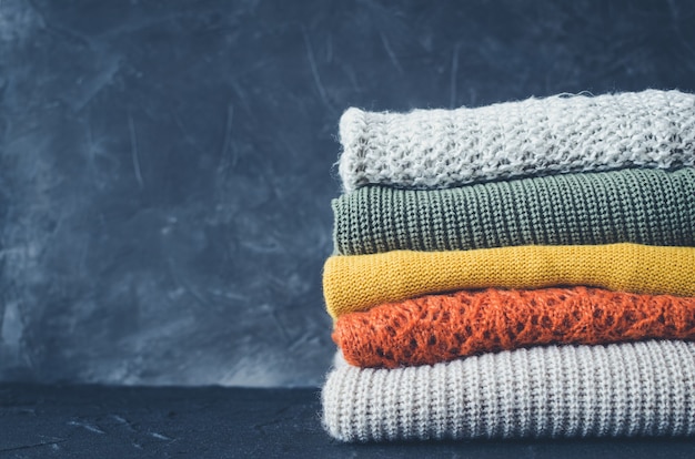 Knitted woolen sweaters on the table