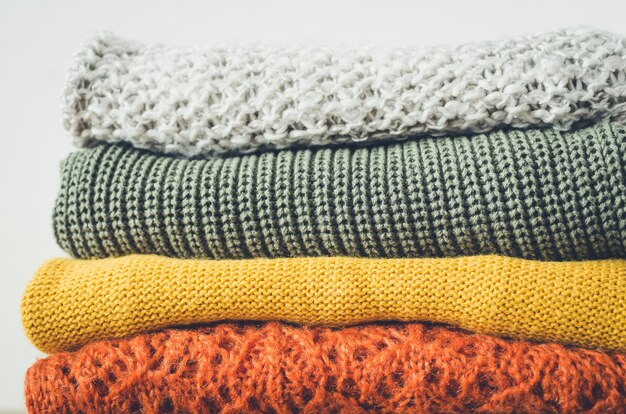 Photo knitted woolen sweaters on the table