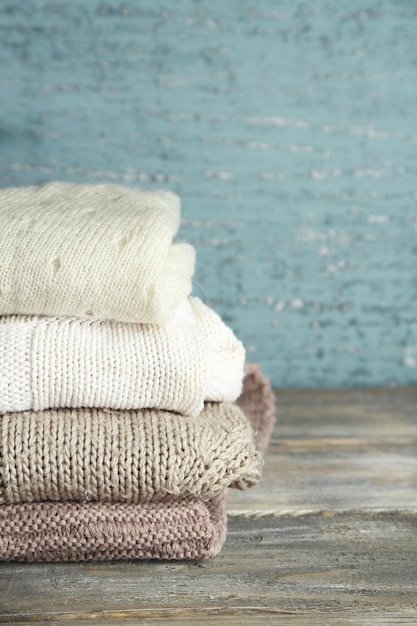 Knitting clothes on wooden background