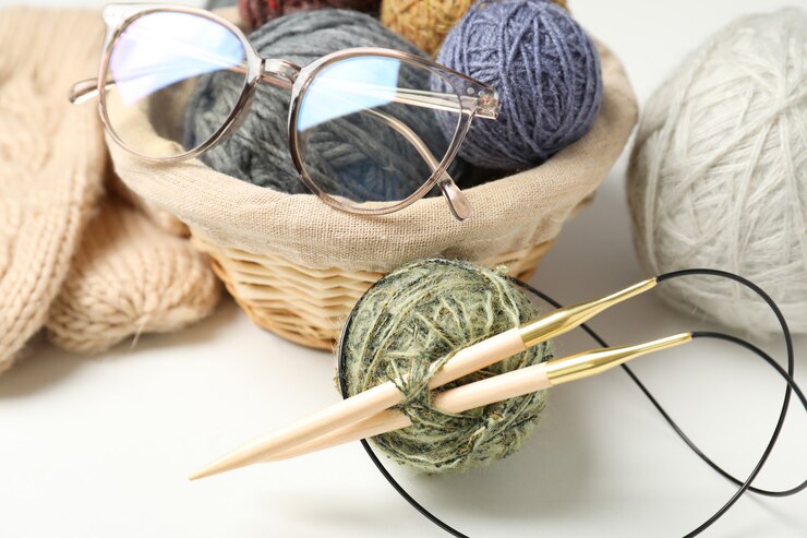 Photo knitting concept with yarn balls on white background.
