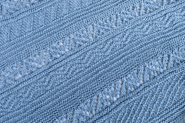 Knitting diagonal and horizontal patterns of natural wool blue