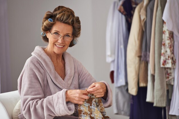 Knitting is my hobby Full length shot of a senior woman knitting at home