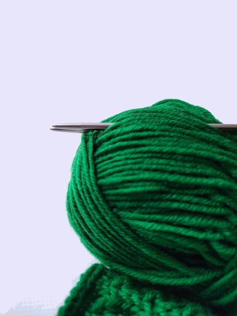 knitting needles and green threads