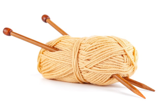 Knitting needles and woolen threads isolated
