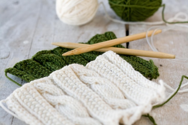 Knitting pattern and needles on a wooden background